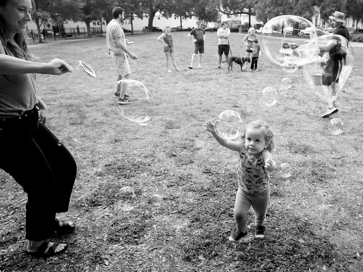 Families play with soap bubbles at Markey Park